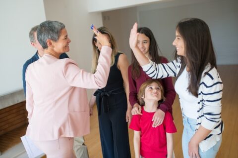 An agent high-fiving a young woman.