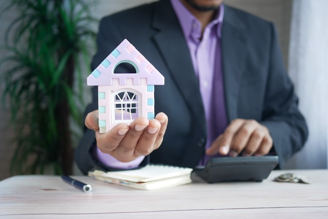 A man doing calculations symbolizes a reason to hire a commercial property manager.