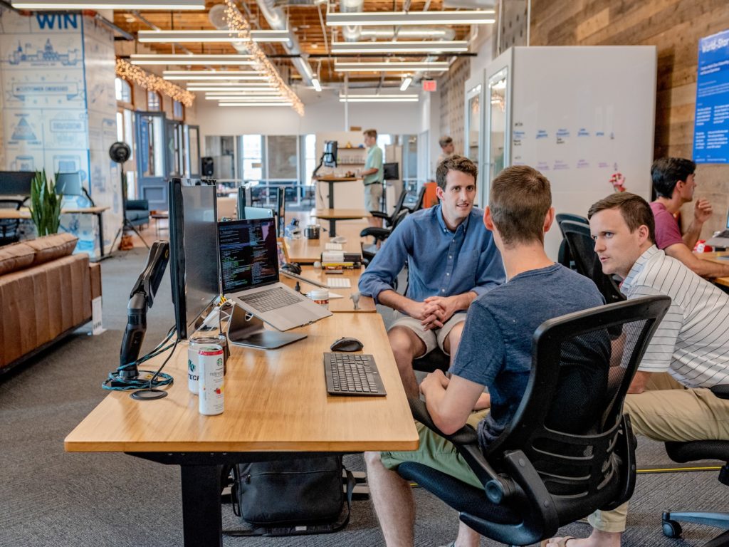 People conversing in an office.